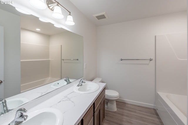 full bathroom with hardwood / wood-style flooring, vanity,  shower combination, and toilet