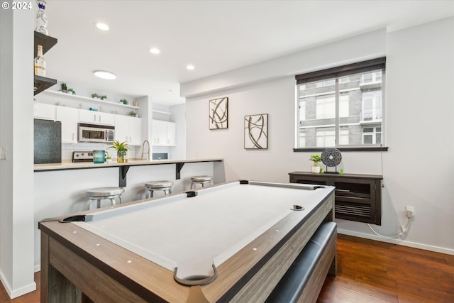 game room featuring pool table, sink, and dark hardwood / wood-style flooring