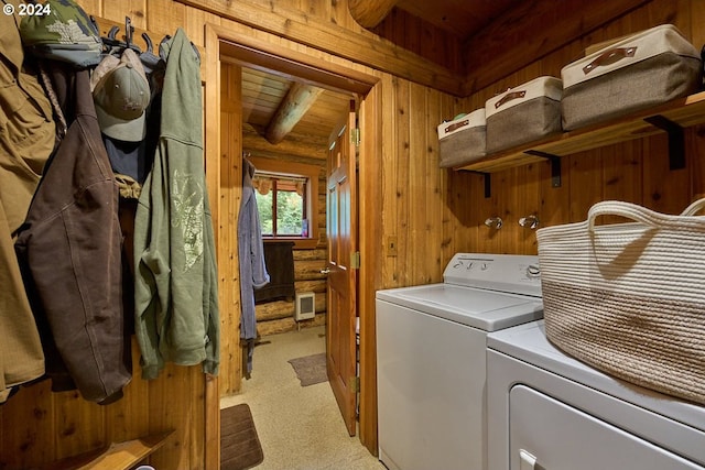 washroom featuring wood ceiling, light carpet, wood walls, and separate washer and dryer