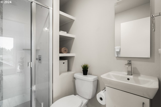 bathroom featuring an enclosed shower, vanity, and toilet