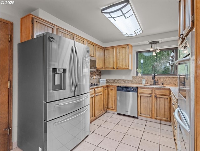 kitchen with stainless steel appliances, sink, and light tile patterned floors