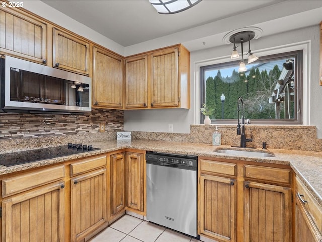 kitchen with sink, backsplash, hanging light fixtures, light tile patterned floors, and stainless steel appliances