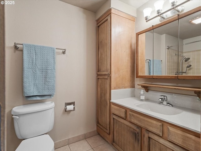 bathroom featuring vanity, toilet, and tile patterned flooring