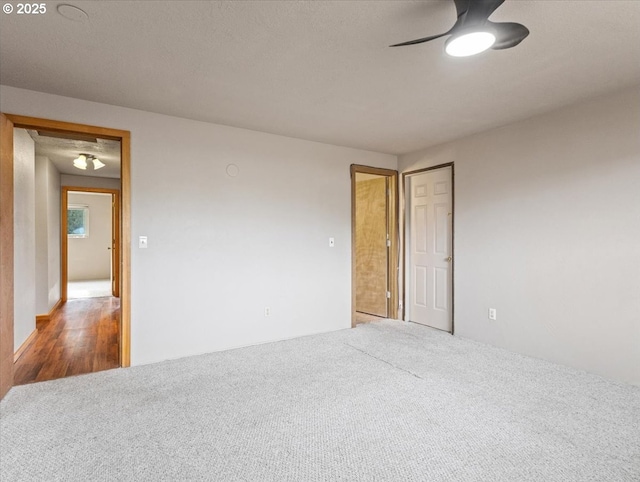 carpeted empty room featuring a textured ceiling and ceiling fan