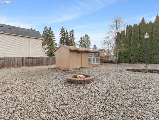 view of yard with a storage shed and a fire pit