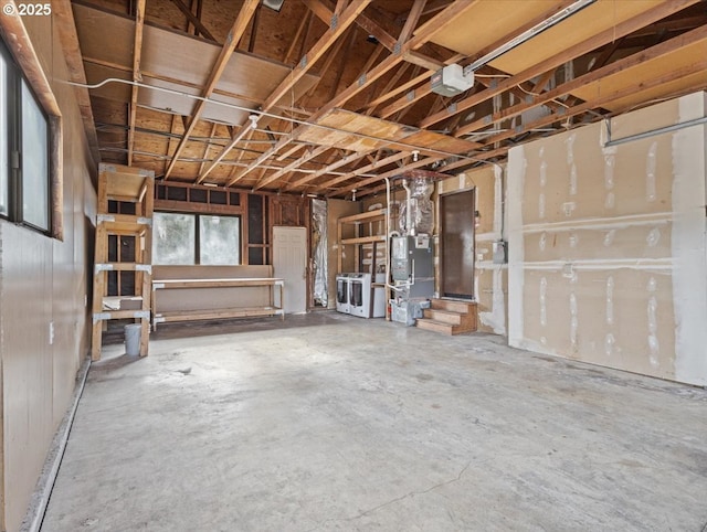 interior space featuring heating unit and washing machine and clothes dryer