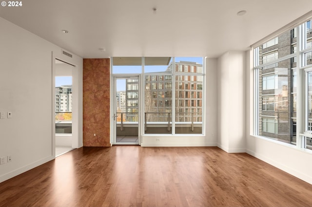 unfurnished room featuring hardwood / wood-style flooring