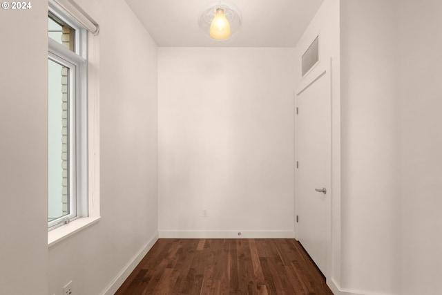 corridor featuring dark wood-type flooring