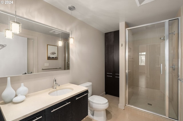 bathroom with tile patterned flooring, vanity, toilet, and walk in shower