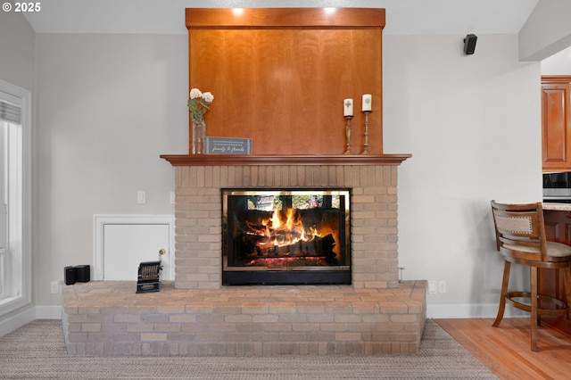 room details featuring hardwood / wood-style flooring and a brick fireplace