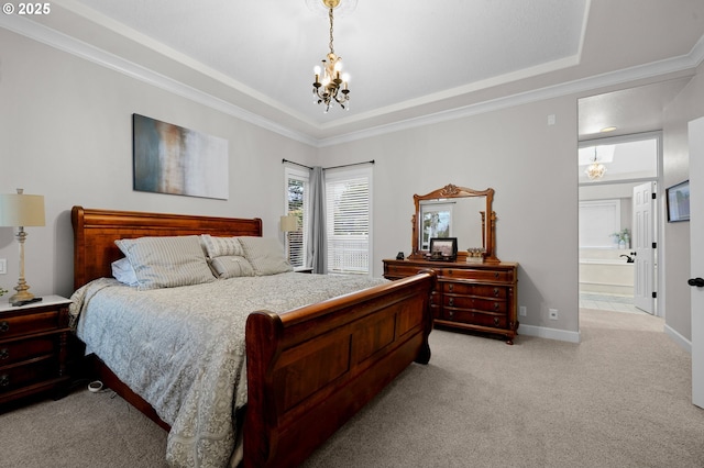 carpeted bedroom with a raised ceiling, ensuite bathroom, ornamental molding, and a notable chandelier