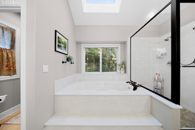 bathroom with lofted ceiling with skylight and plus walk in shower