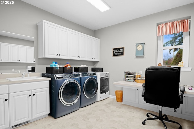 laundry room featuring sink, cabinets, and washing machine and clothes dryer