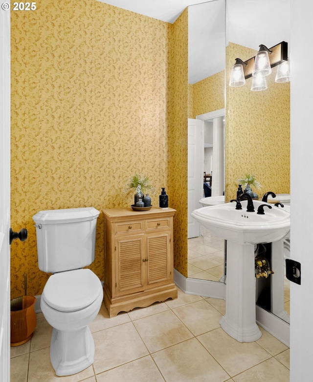 bathroom featuring tile patterned flooring, sink, and toilet