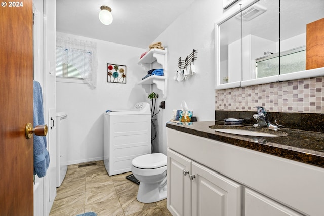 bathroom featuring vanity, toilet, and tasteful backsplash