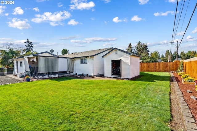 rear view of property with a yard and a patio