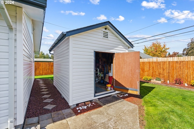 view of outbuilding featuring a lawn