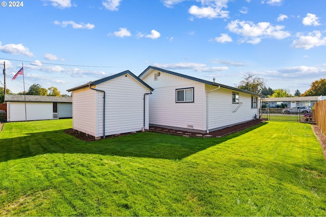 rear view of house featuring a yard