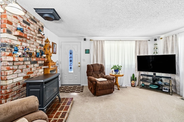 living room featuring a wood stove, a textured ceiling, and dark carpet