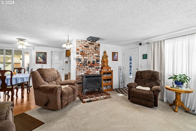 living room featuring a wood stove, carpet floors, and a wealth of natural light