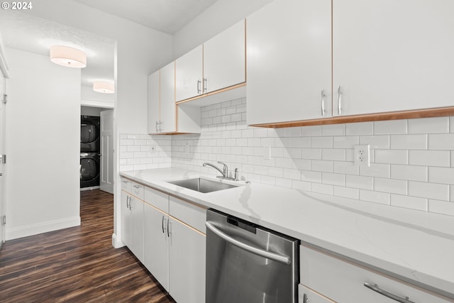 kitchen with white cabinetry, dishwasher, stacked washer / drying machine, and sink