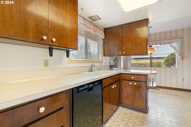 kitchen with kitchen peninsula, black dishwasher, and sink