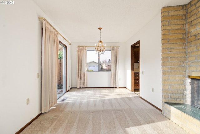 interior space featuring a brick fireplace, carpet floors, and a chandelier