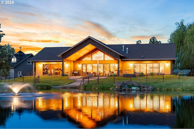 exterior space featuring a yard and a water view