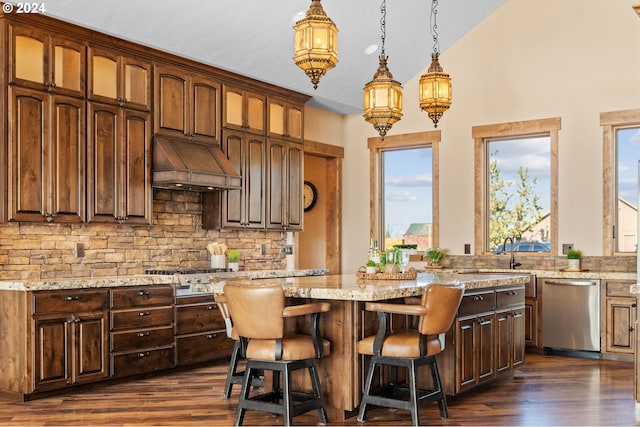 kitchen featuring a center island, stainless steel appliances, plenty of natural light, and custom exhaust hood