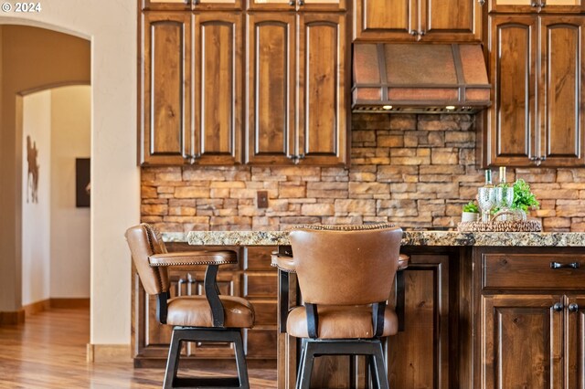 kitchen with light stone counters and light wood-type flooring