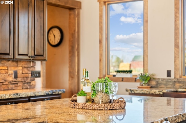 kitchen with light stone countertops and plenty of natural light