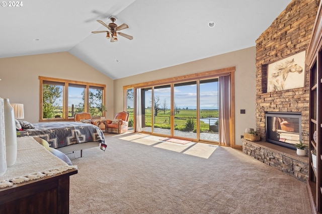 bedroom featuring carpet flooring, access to exterior, ceiling fan, a stone fireplace, and lofted ceiling