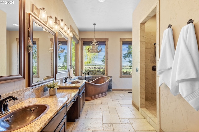 bathroom featuring vanity, separate shower and tub, and an inviting chandelier