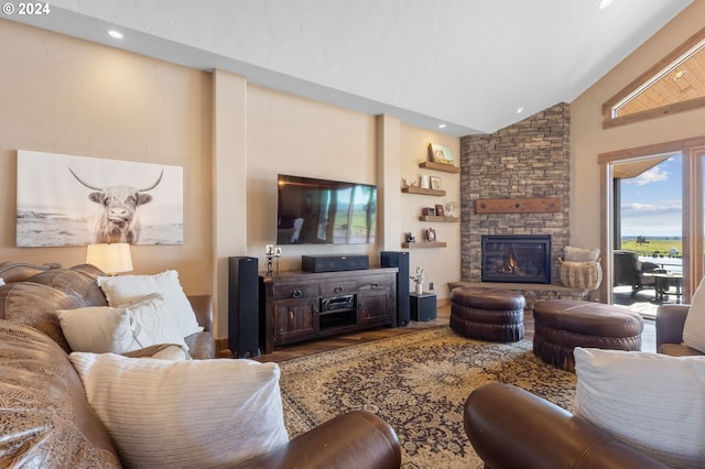 living room featuring a stone fireplace and high vaulted ceiling