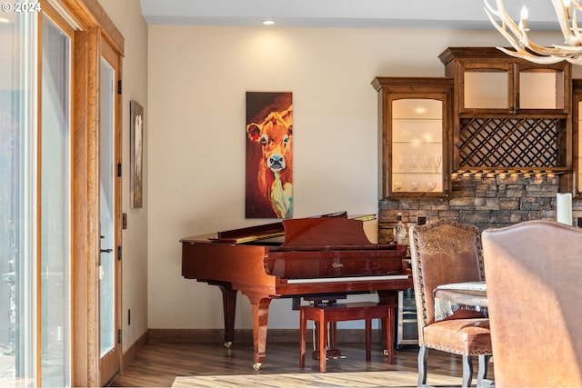 misc room with wood-type flooring and an inviting chandelier