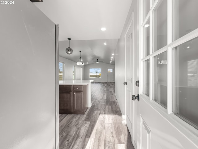 hall with hardwood / wood-style flooring and vaulted ceiling