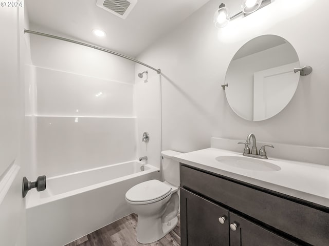 full bathroom featuring toilet, hardwood / wood-style floors, vanity, and washtub / shower combination