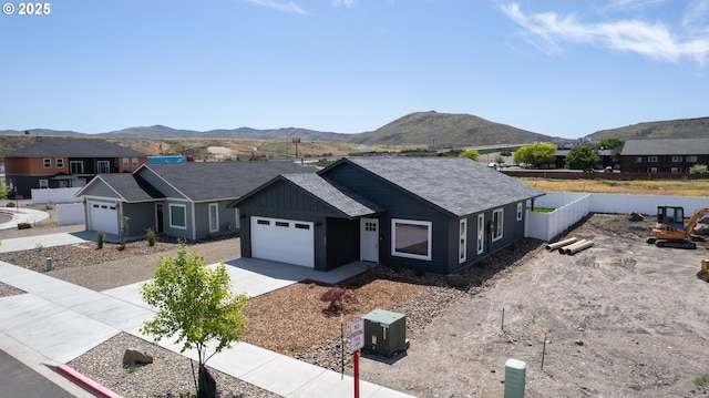 660 E St E, Baker City, OR 97814 - view of front of property with a mountain view, an attached garage, driveway, and board and batten siding