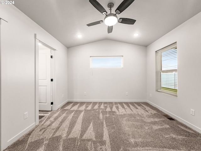 spare room with carpet floors, ceiling fan, and lofted ceiling