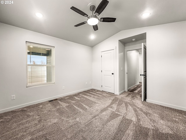 unfurnished bedroom with carpet, ceiling fan, lofted ceiling, and a closet