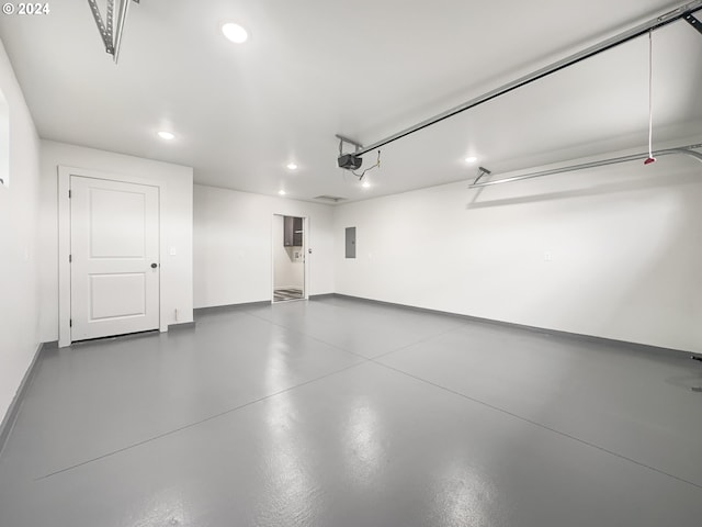 garage with electric panel and a garage door opener