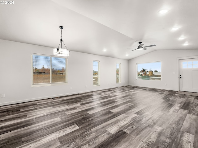 unfurnished living room featuring ceiling fan with notable chandelier, dark wood-type flooring, and lofted ceiling