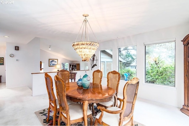 carpeted dining space featuring lofted ceiling and an inviting chandelier