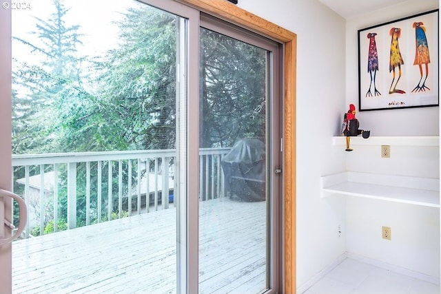 doorway to outside with light tile flooring