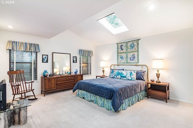 bedroom featuring light colored carpet and vaulted ceiling with skylight