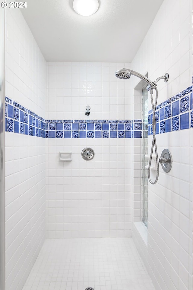 bathroom with a tile shower