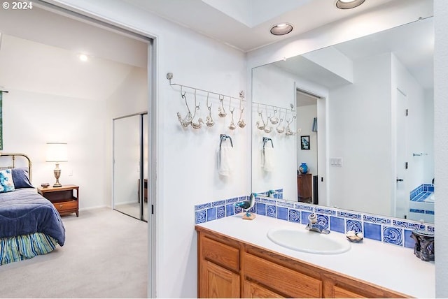 bathroom with vaulted ceiling and vanity