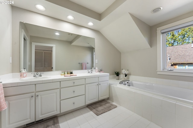 bathroom with tile patterned floors, tiled bath, and vanity