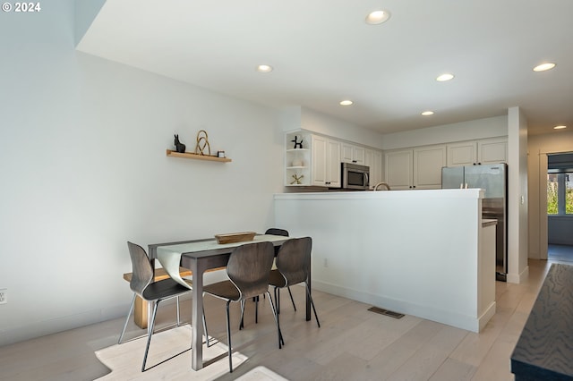 dining room with light hardwood / wood-style flooring