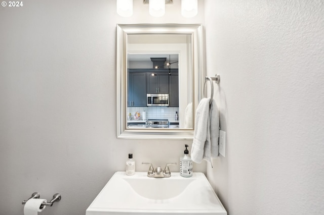 bathroom featuring backsplash and sink